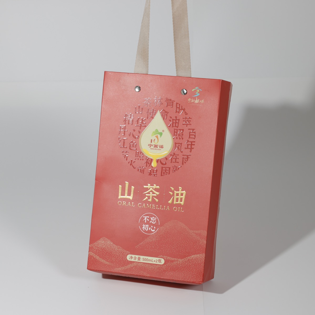 Oral Camellia Oil 山茶油 — red gift carrier bag with gold hot foil calligraphy and riveted ribbon handles